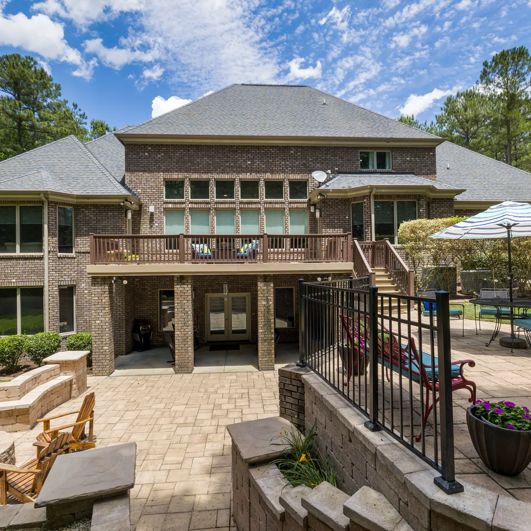 Landscaped backyard with a stone patio
